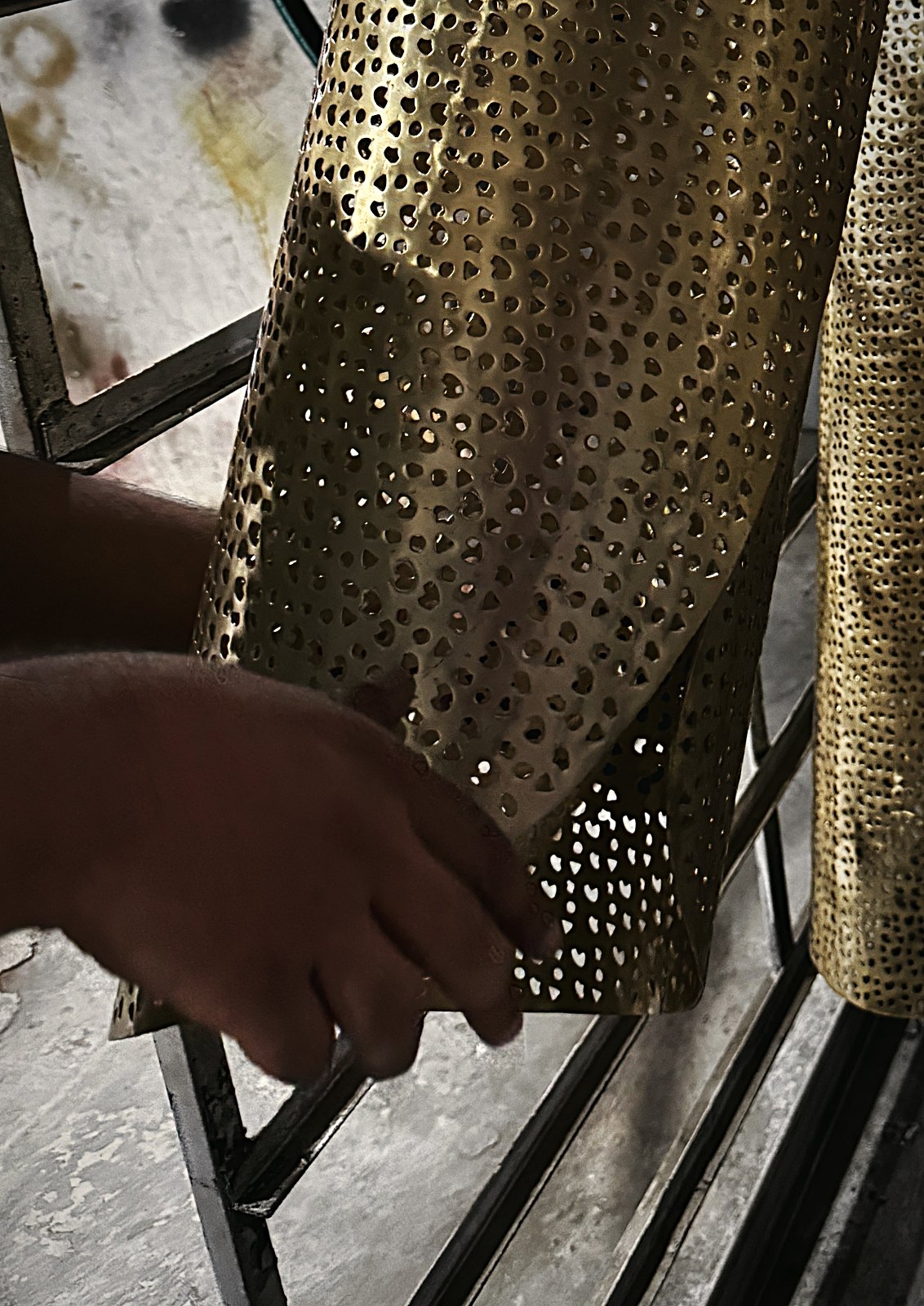 A pierced shade handled on the rack